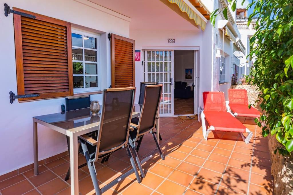 a patio with a table and chairs on a porch at Apartment Chateau Morro 4 in Morro del Jable