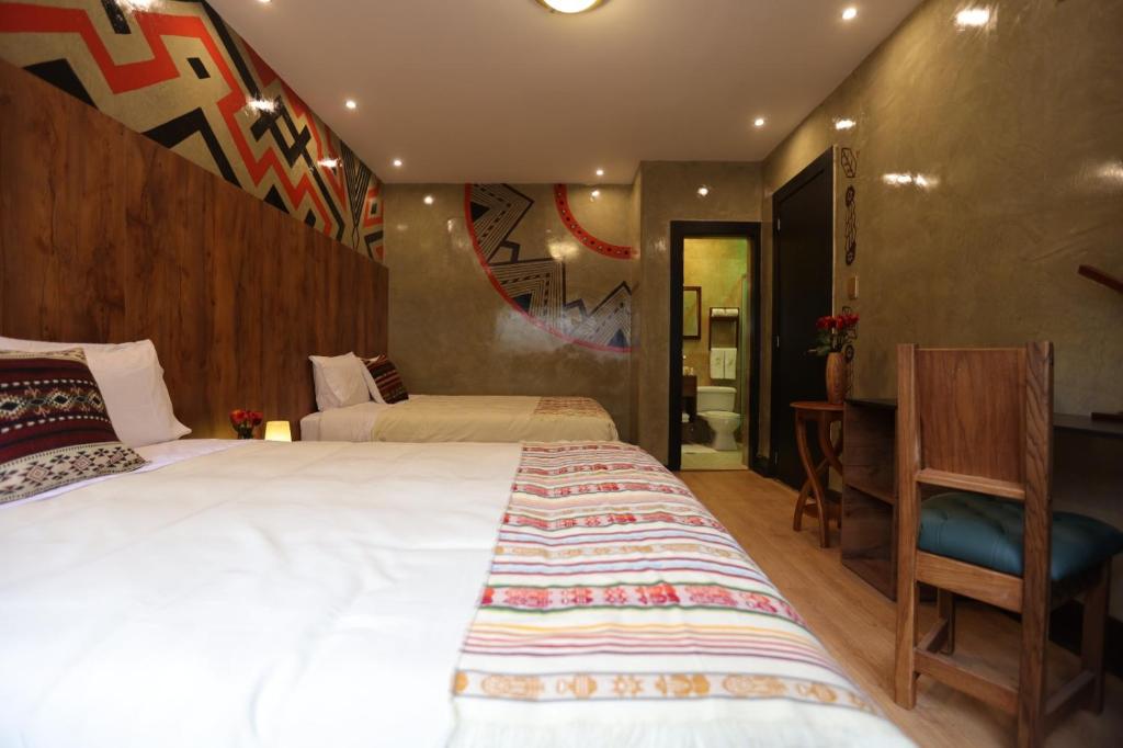 Postel nebo postele na pokoji v ubytování Chakana Hotel Boutique Mariscal
