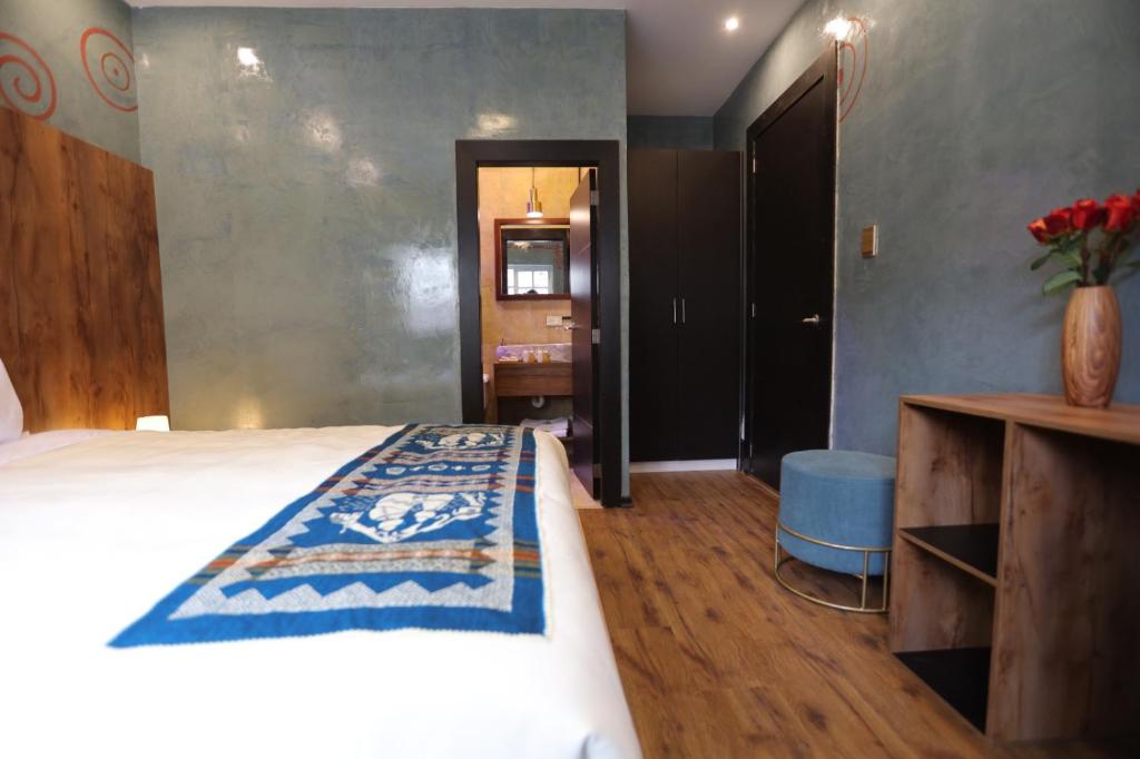 Postel nebo postele na pokoji v ubytování Chakana Hotel Boutique Mariscal