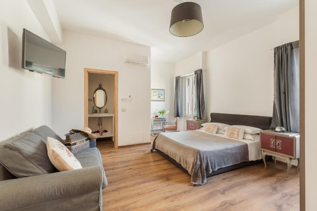 a living room with a bed and a couch at Guest House Maison 6 in Lido di Ostia