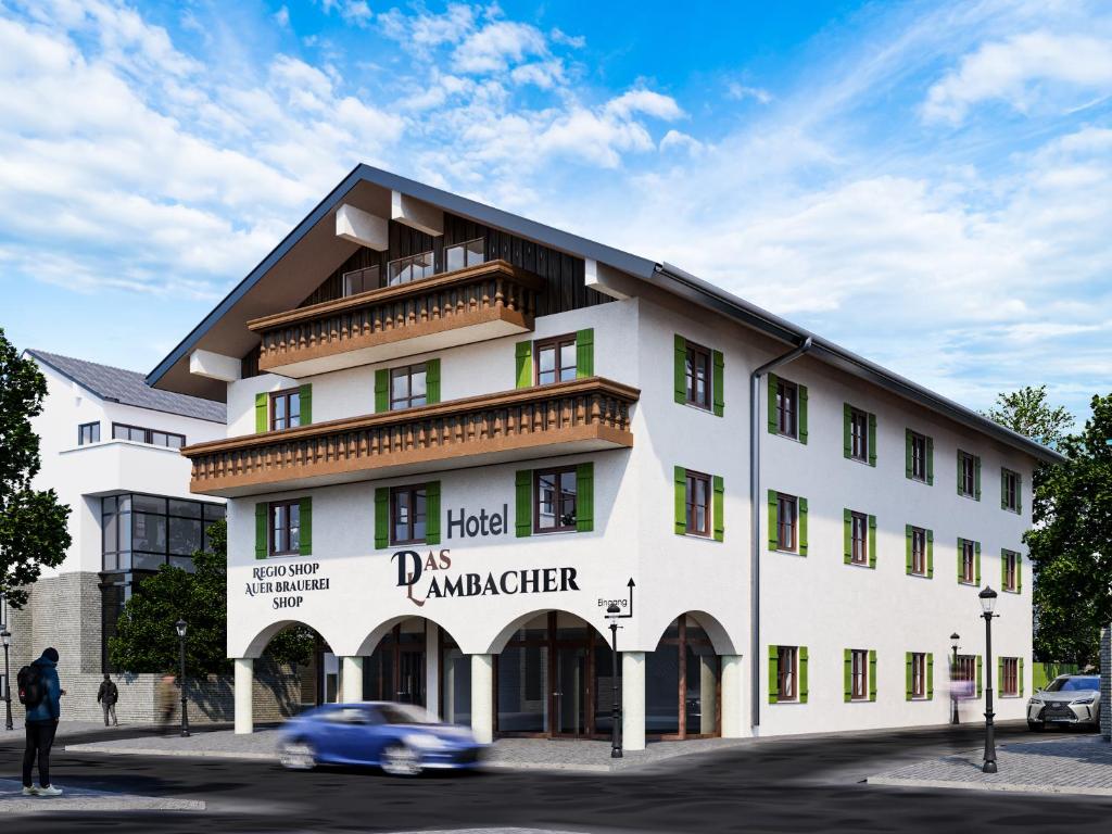 a white building with a car in front of it at Das Lambacher in Oberaudorf