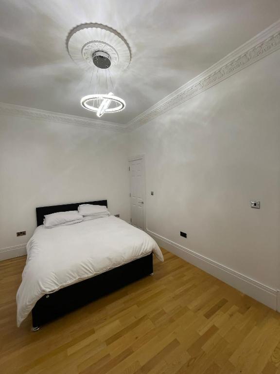 a white bedroom with a bed and a ceiling at VIP penthouse own bathroom one bedroom on suite in Wolverhampton
