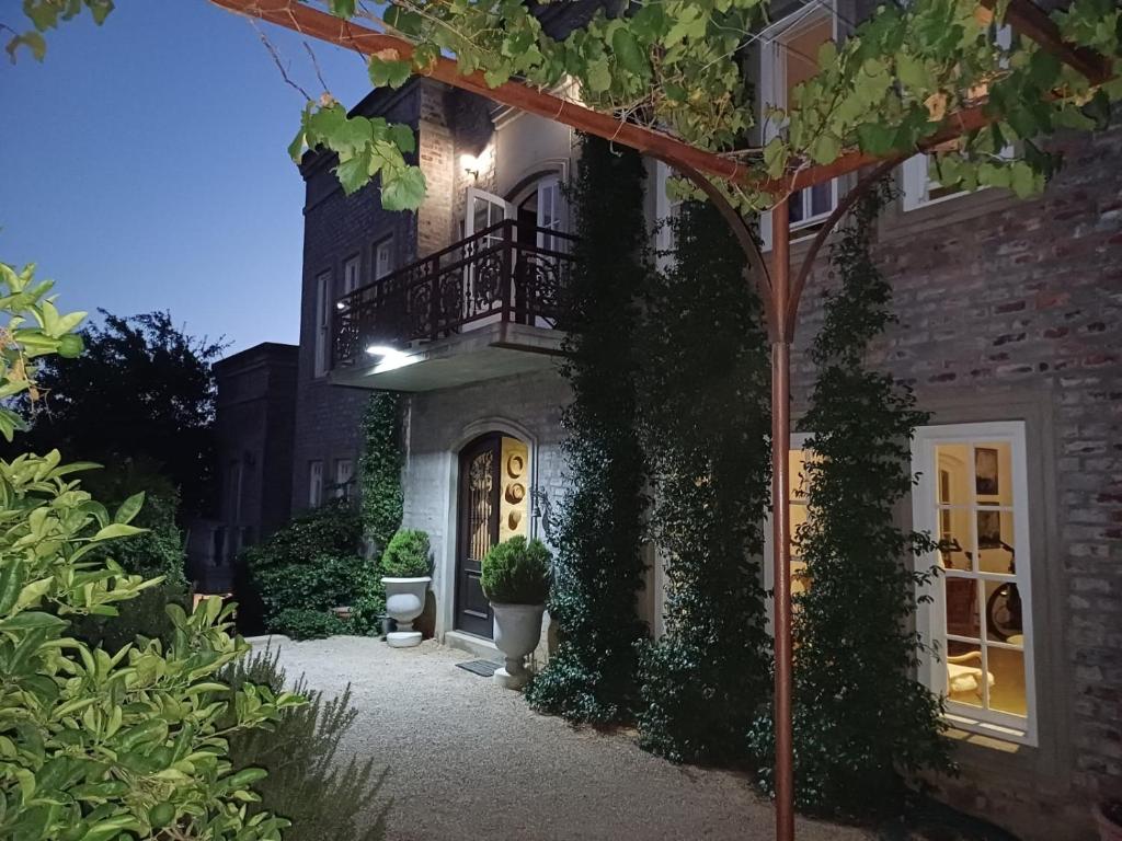 a house with a balcony on the side of it at Villa Anna Katarina in Riebeek-Kasteel