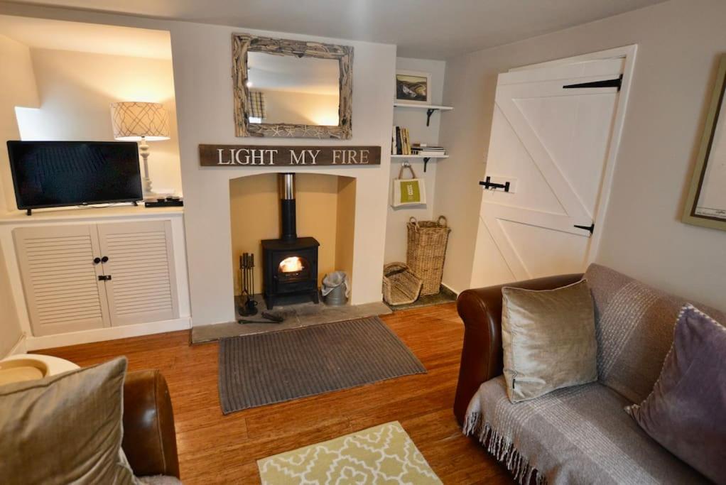 a living room with a couch and a fire place at Tern Quay Cottage, Birdwatching Dream! Crabpot Cottages Sheringham in Cley next the Sea