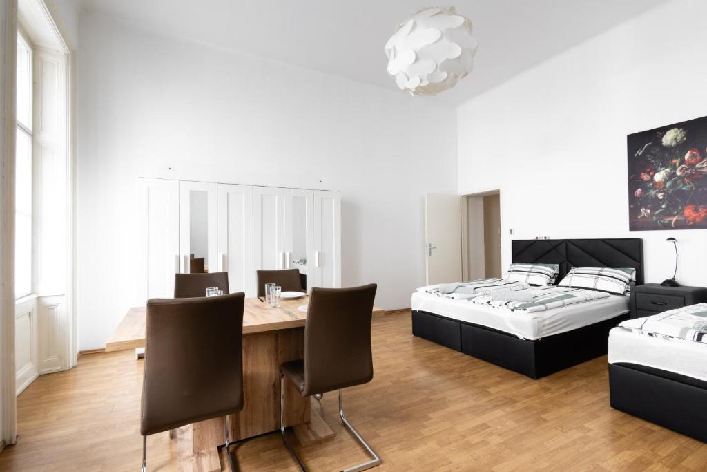 a bedroom with a dining table and a bed at Getreide T13 in Vienna