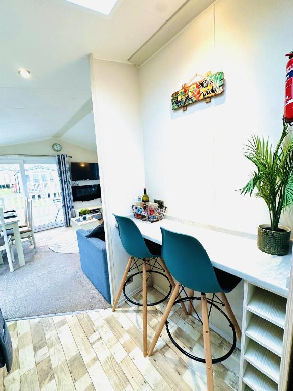 a kitchen with a table and two chairs at Ocean Breeze in Filey