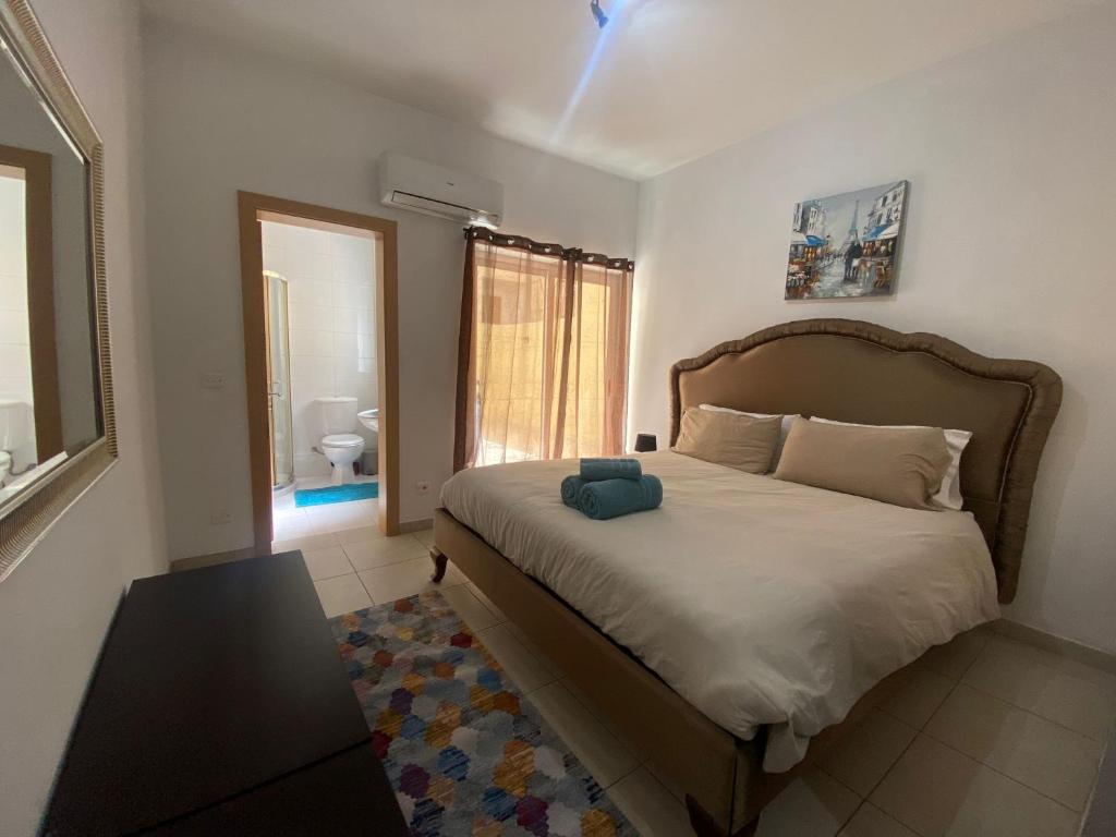 a bedroom with a bed with a blue towel on it at Sliema 2bed with Backyard in Sliema