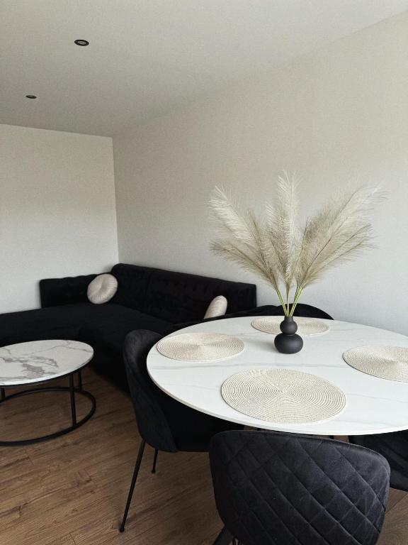 a living room with a table and a couch at Sea Oasis apartment in Liepāja