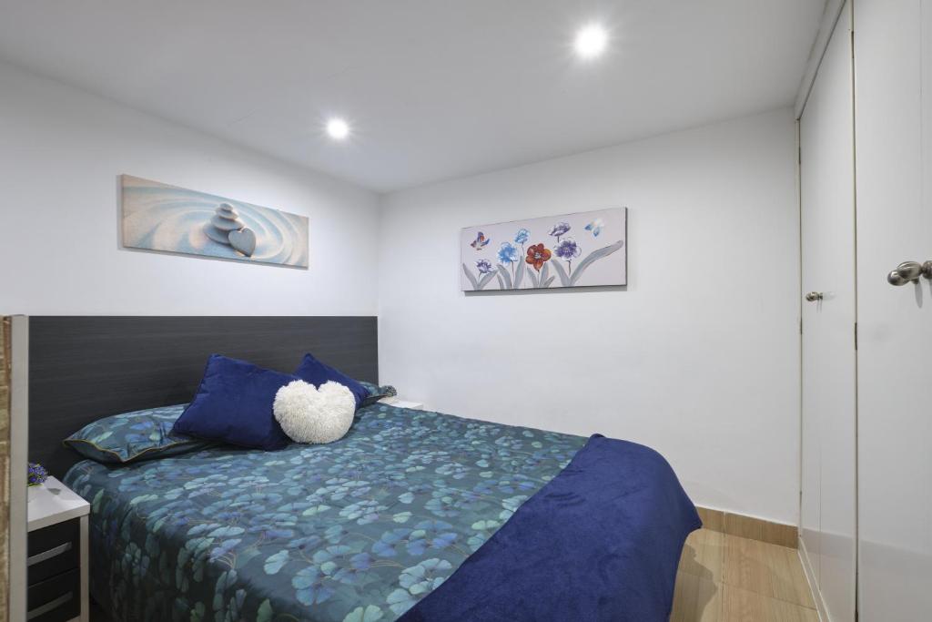 um quarto com uma cama azul com um ursinho de peluche em Half moon Piccadilly em Londres