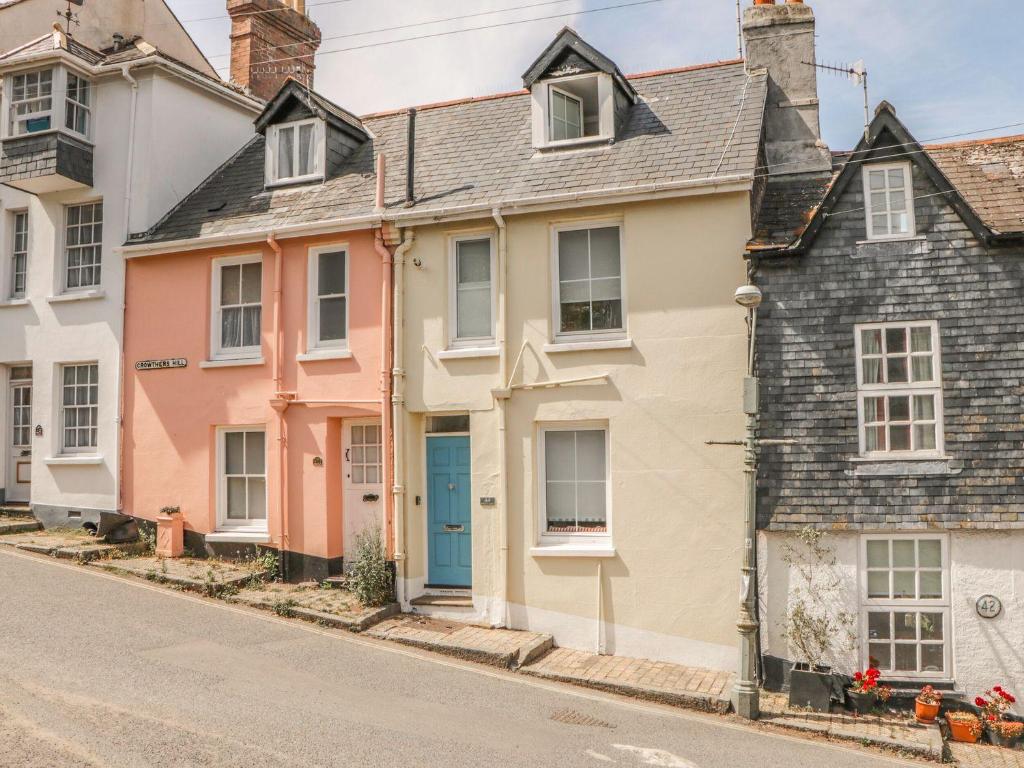 a row of colourful houses on a street at Topsail in Dartmouth