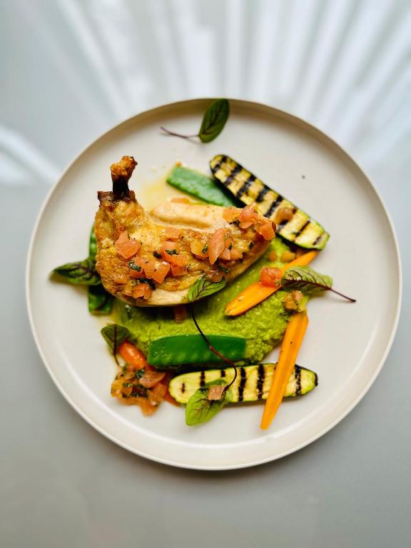 a plate of food with fish and vegetables on it at Clarion Congress Hotel Bratislava in Bratislava