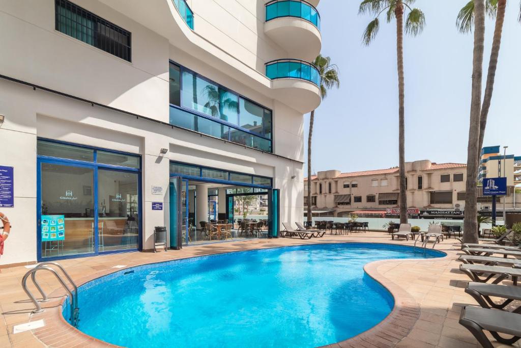 a swimming pool in front of a building at Hotel Cibeles Playa in Gandía