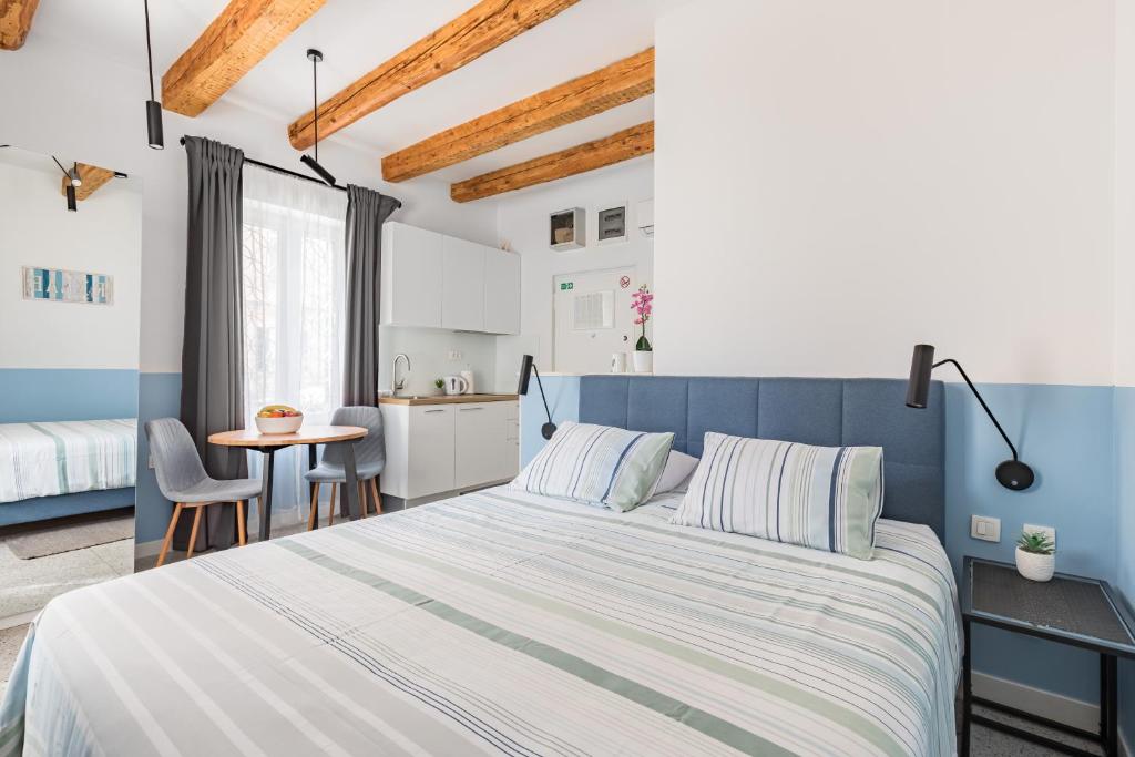 een slaapkamer met een groot bed en een keuken bij Luxury Studio Adriatic 2 in Split