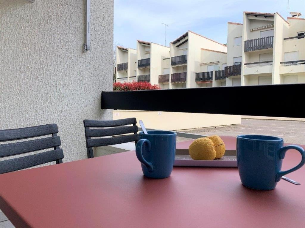 dos tazas en una mesa con un plato de comida en Saint Georges de Didonne - VACANCES à PETIT BUDGET - STUDIO CABINE, en Saint-Georges-de-Didonne