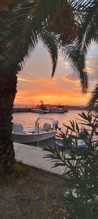 a group of boats on the water at sunset at Alex house Thassos in Skala Sotiros