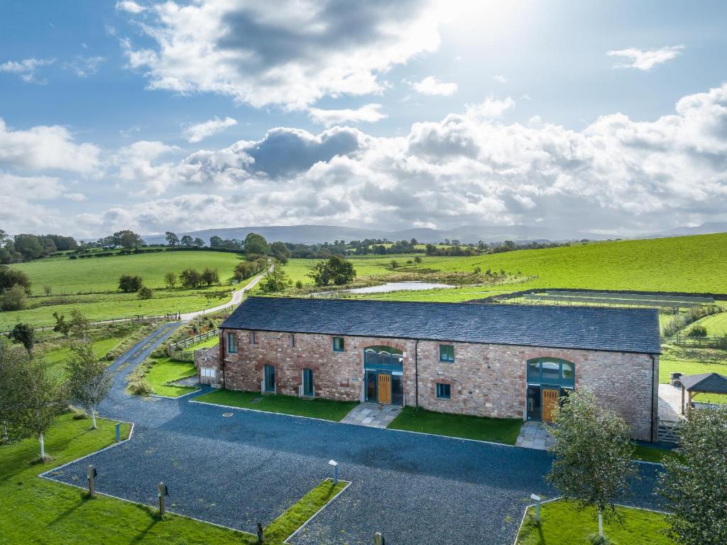 an aerial view of a stone barn in a field at Brockram & Keld Barns in Kirkby Stephen