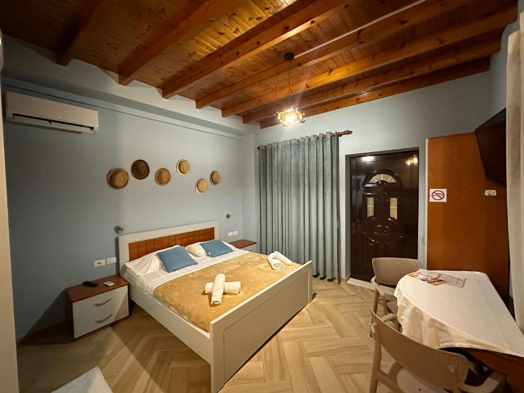 a bedroom with a large bed and a table at Vila Arial in Vlorë