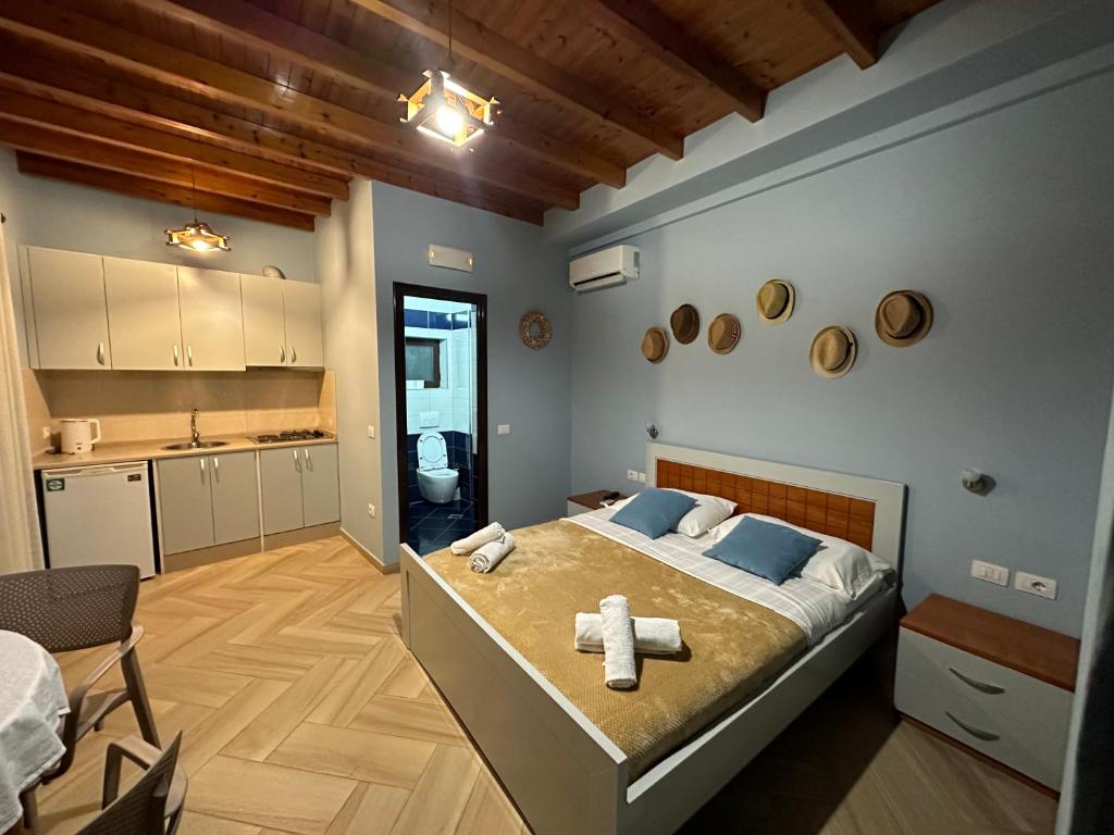 a bedroom with a large bed with towels on it at Vila Arial in Vlorë