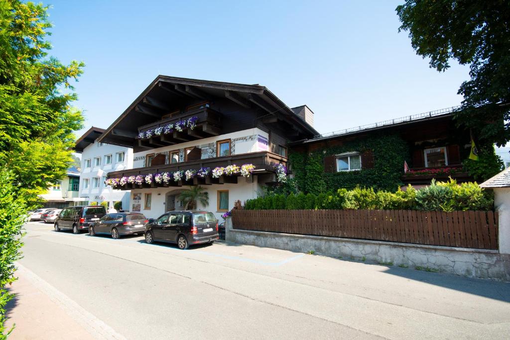 a building with cars parked on the side of a street at Pension Max in Zell am See