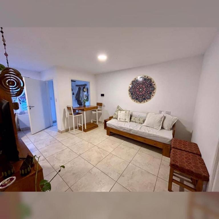 a living room with a couch and a table at Corinto Tempo in Esquel