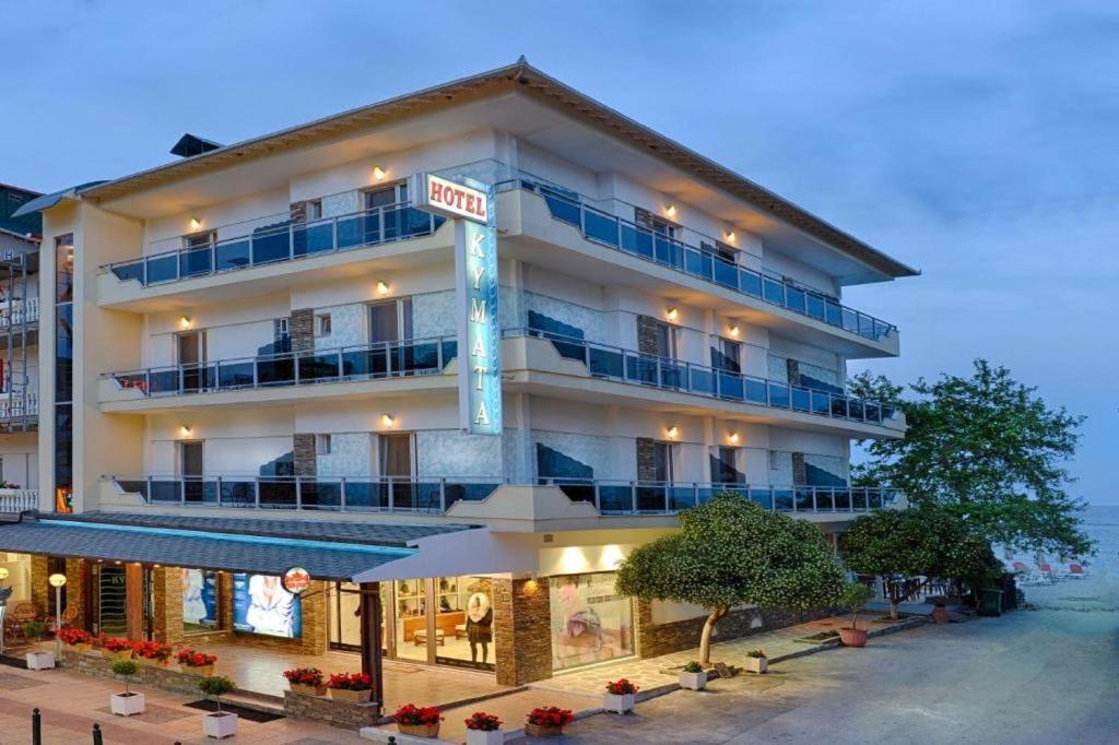 a hotel building with a sign that reads hotel at Kymata in Paralia Katerinis