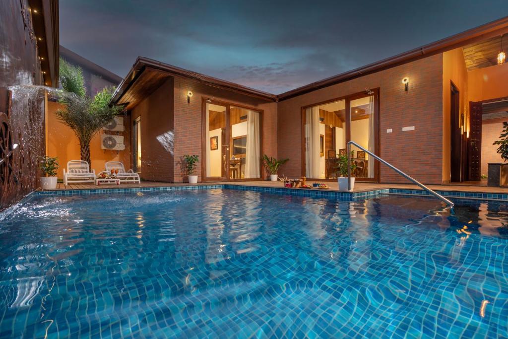 a swimming pool in the middle of a house at Uday Backwater Resort in Alleppey
