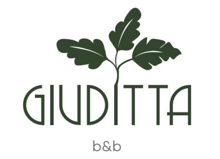un logotipo de una planta con el wordchildha en Giuditta B&B stanza, en Cirié