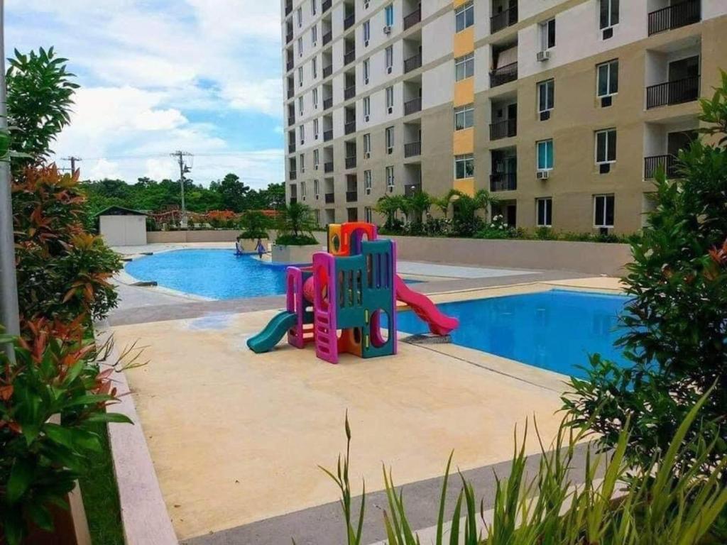 a playground in front of a swimming pool at Saekyung Village One-Phase 2 in Lapu Lapu City