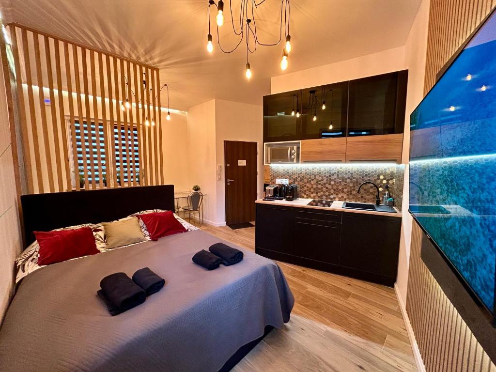 a bedroom with a large bed and a large aquarium at Ocean Black jacuzzi in Kraków