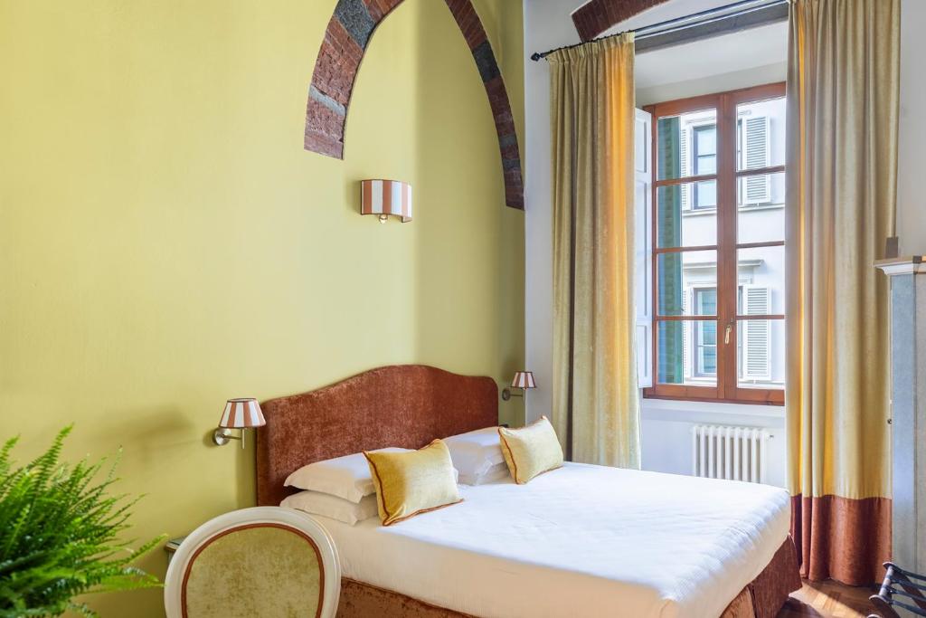 Postel nebo postele na pokoji v ubytování Residenza Della Signoria