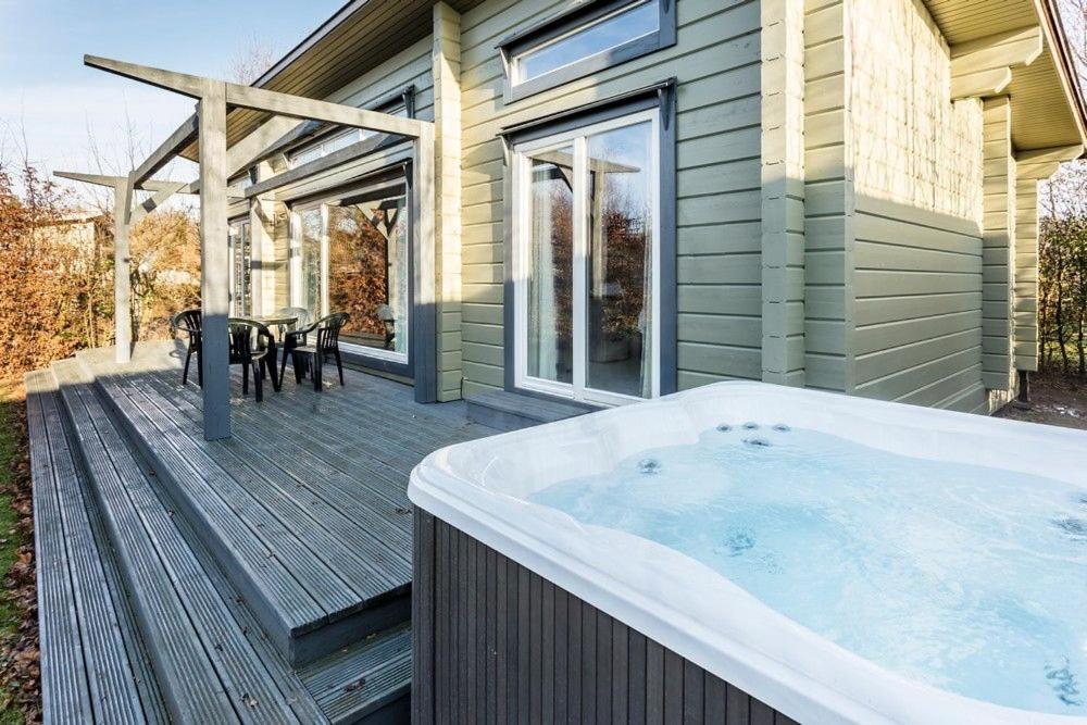a hot tub on the deck of a house at Roydon Marina - Lodge 8 - Hot Tub - Pet Friendly in Roydon