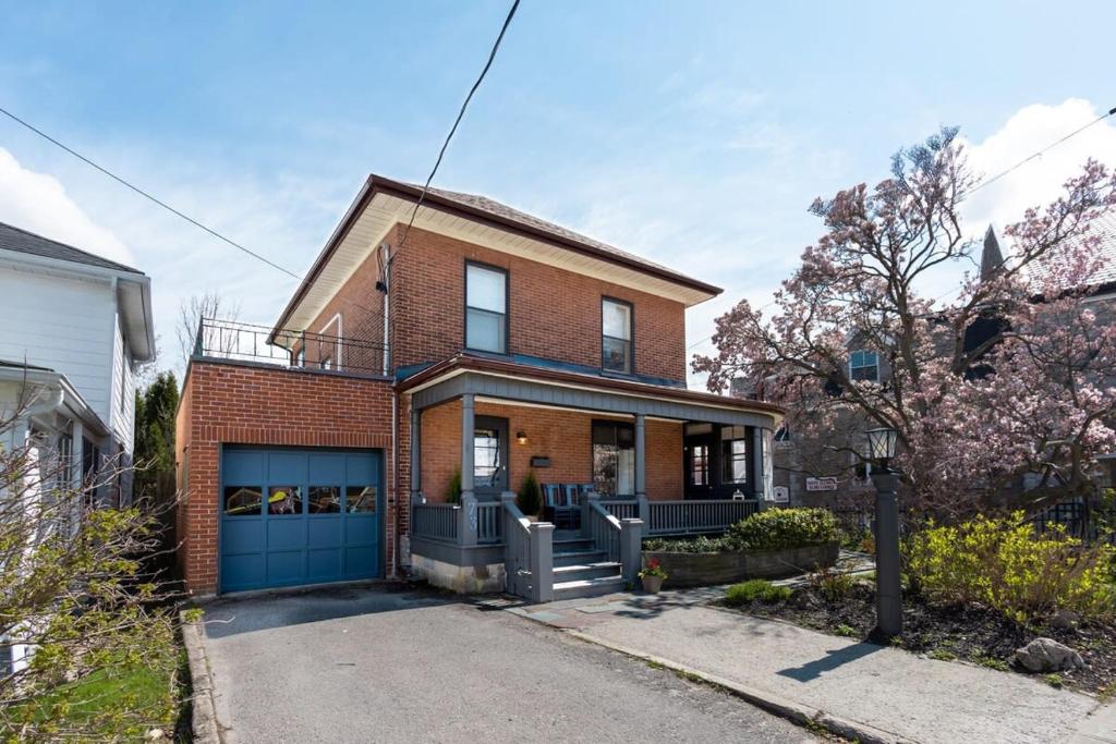 a brick house with a blue garage at Merlot on Mary in Picton