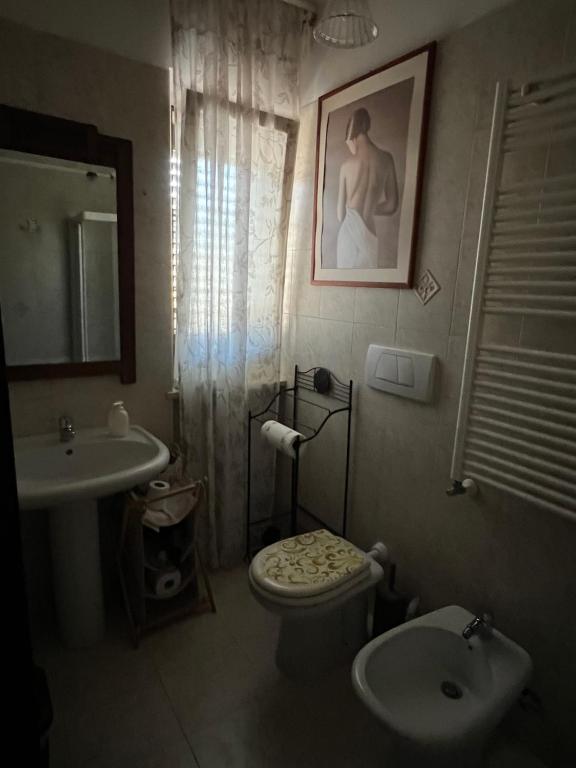 a bathroom with a toilet and a sink at Prospettiva Polignano in Polignano a Mare