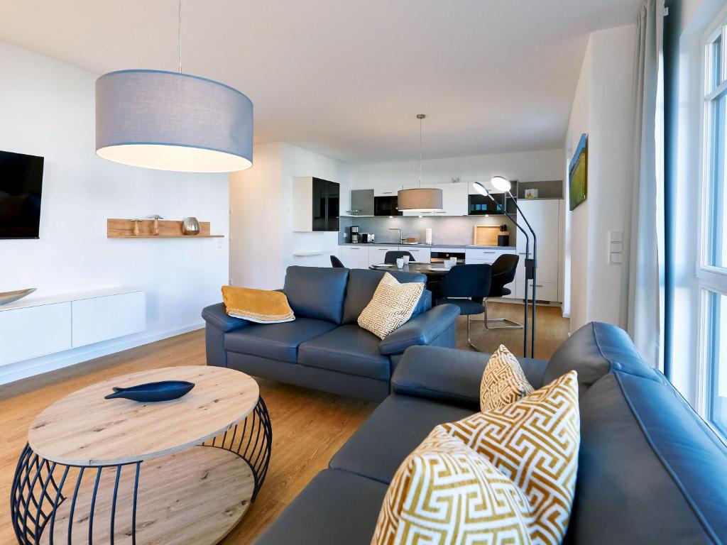a living room with a couch and a table at Villa Beatrice - Wohnung 03 in Binz