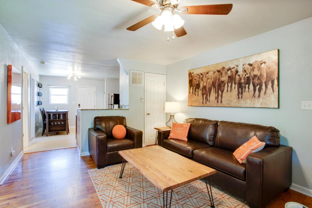 a living room with a couch and a table at Walkable OSU Apartment - 6 Blocks to Stadium! in Stillwater