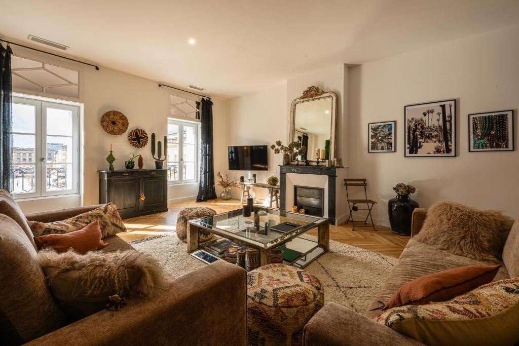 a living room with a couch and a coffee table at Apt 4 * vue cathédrale Pey Berland in Bordeaux