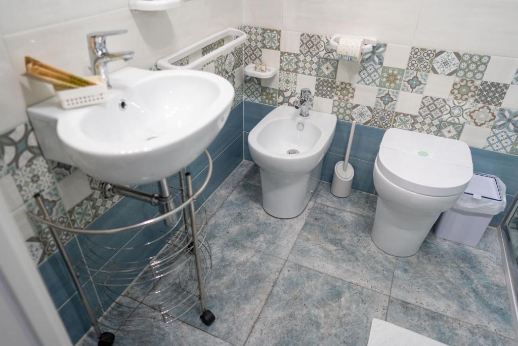 a bathroom with a sink and a toilet at B&b Anna's home in Marina di Camerota