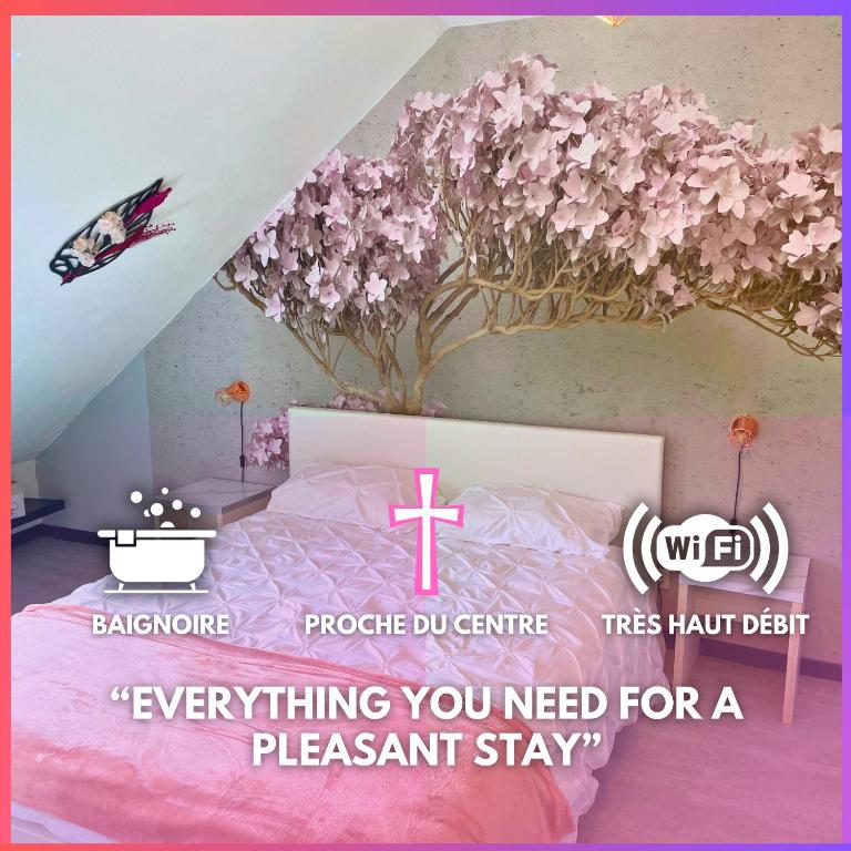 a room with a bed with a tree on the wall at [Rêve Rose] Studio Équipé, Wifi, Vue in Lourdes