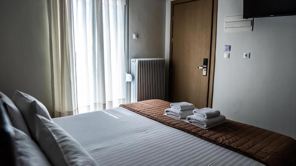 Posteľ alebo postele v izbe v ubytovaní Rooms Batalogianni