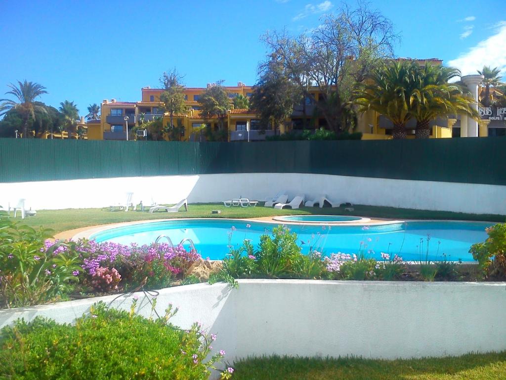 a swimming pool in the yard of a house at Ferias Vilamoura in Vilamoura