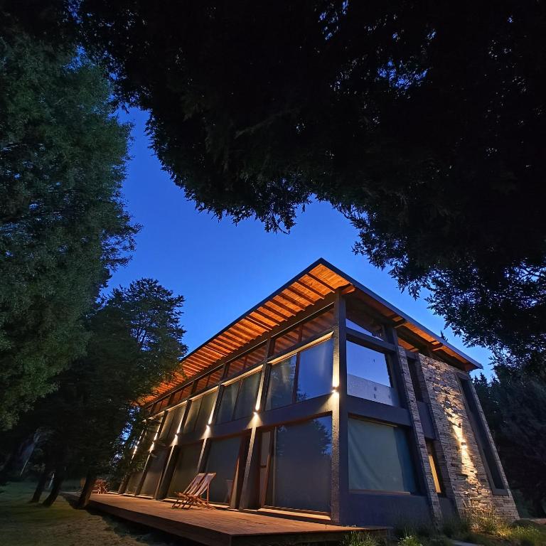 a house with a large window on the side of it at ANFITEATRO APARTS & LOFTS in San Carlos de Bariloche