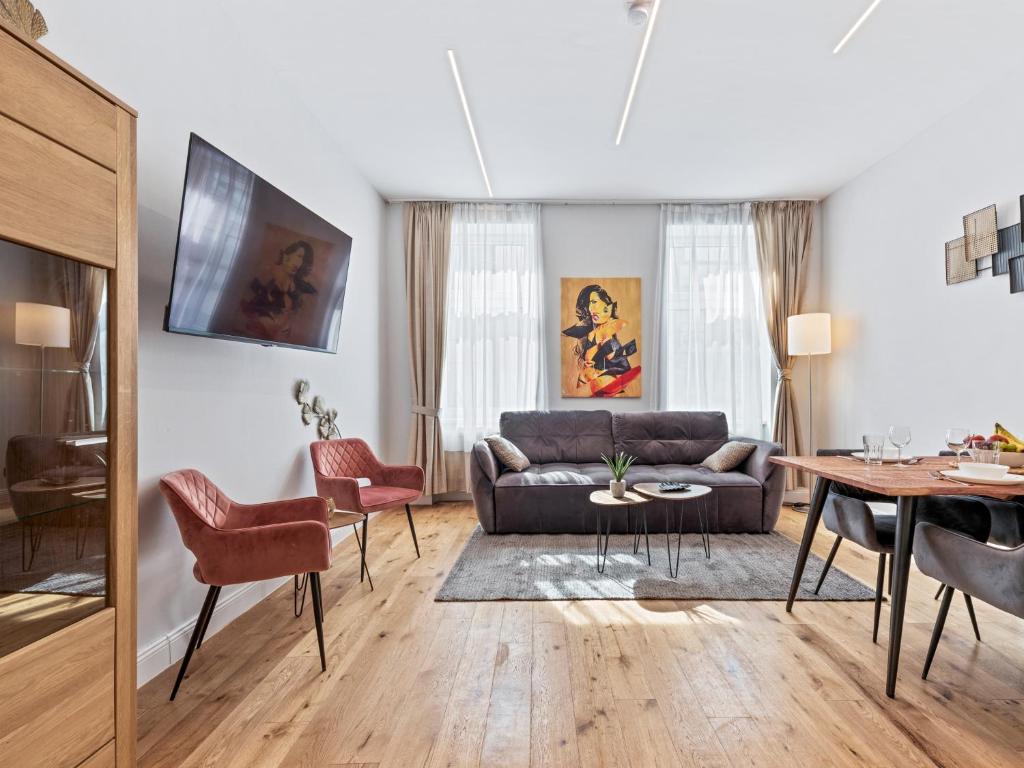 a living room with a couch and a table at SKY9 Apartments District 17 in Vienna