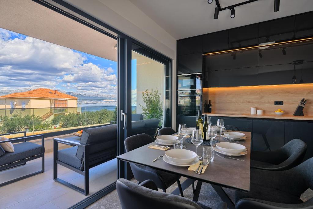a dining room with a table and a view of the ocean at Vice's Place - Sea-View & Pool in Slatine