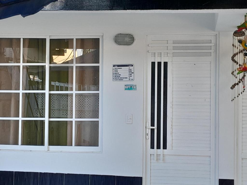 a white door of a house with a window at Brisas del Mar Apto 1A in San Andrés