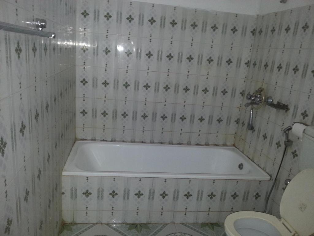 a bathroom with a tub and a toilet at Hotel Shiva's Dream in Sauraha