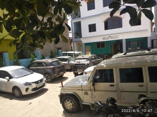 a group of cars parked in a parking lot at Milan Palace Deoghar in Deoghar