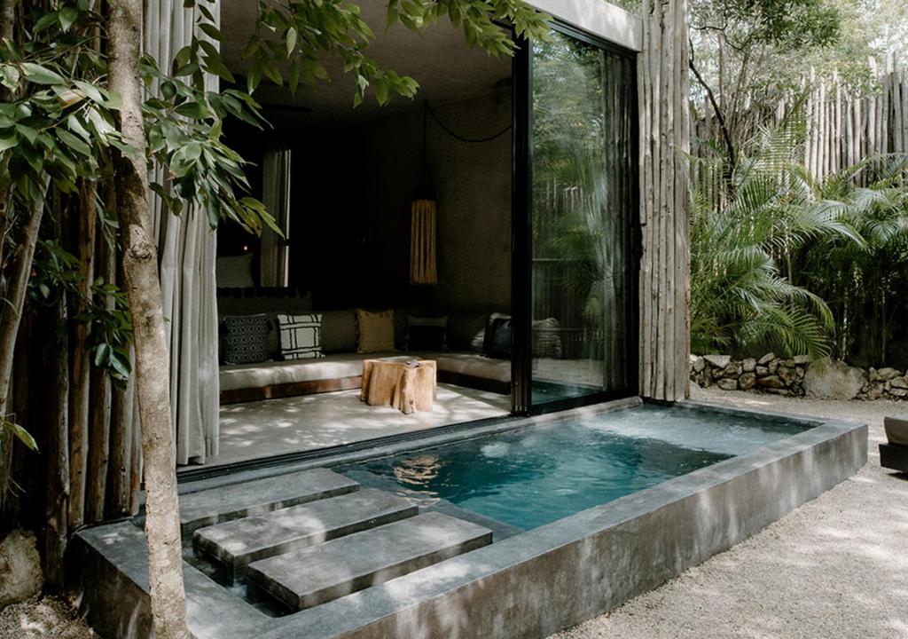 a swimming pool in the middle of a house at Hotel Bardo - Adults Only in Tulum