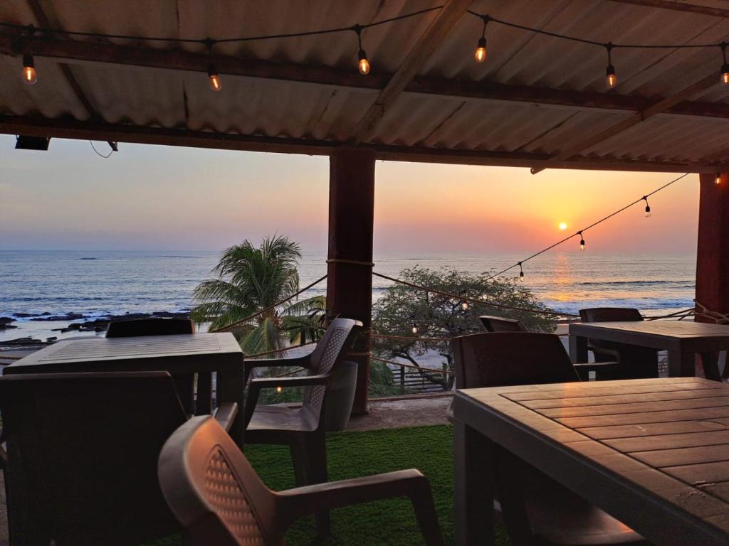 a restaurant with a view of the ocean at sunset at Horizonte Azul in Casares