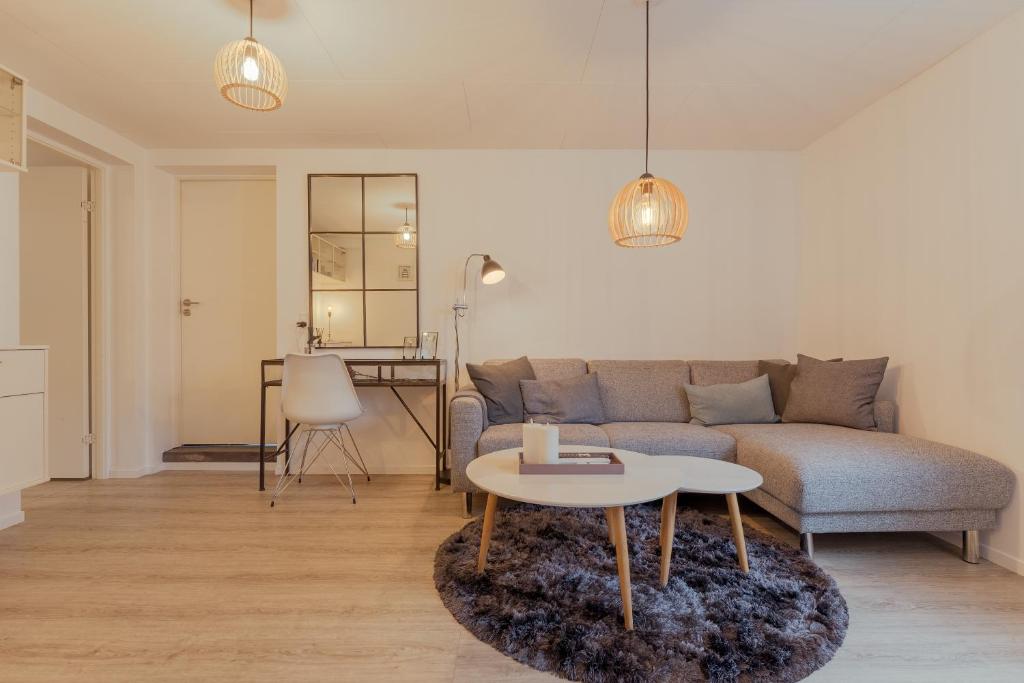 a living room with a couch and a table at Lovely Apartment / 10 min walk from city centre in Tórshavn