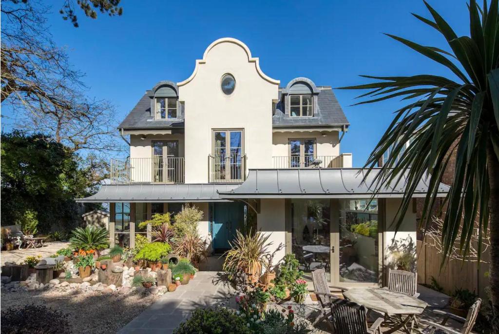 a large white house with a lot of plants at Captivating 7-Bed House in Bristol in Bristol
